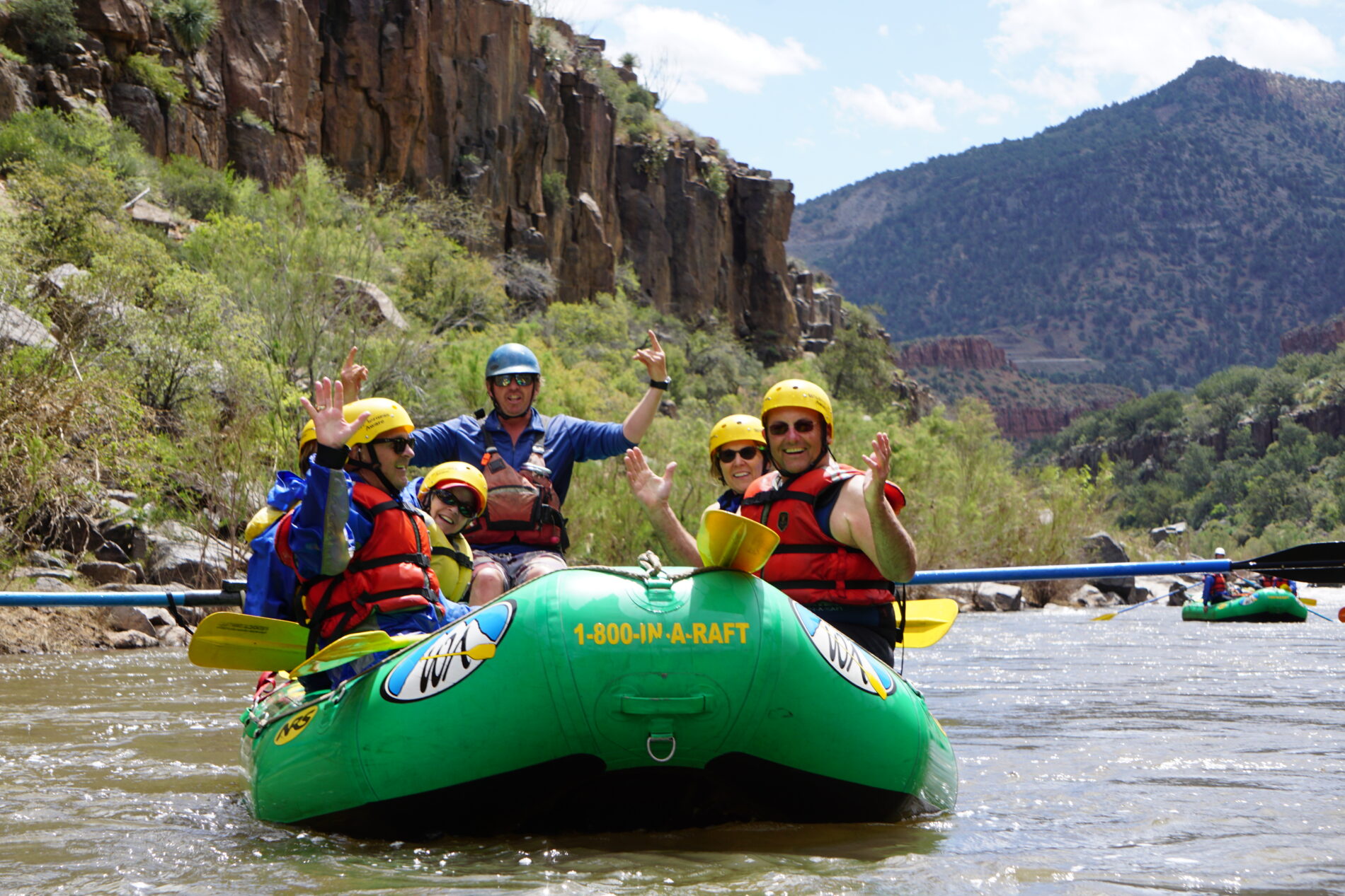a green raft filled with people on the Salt River