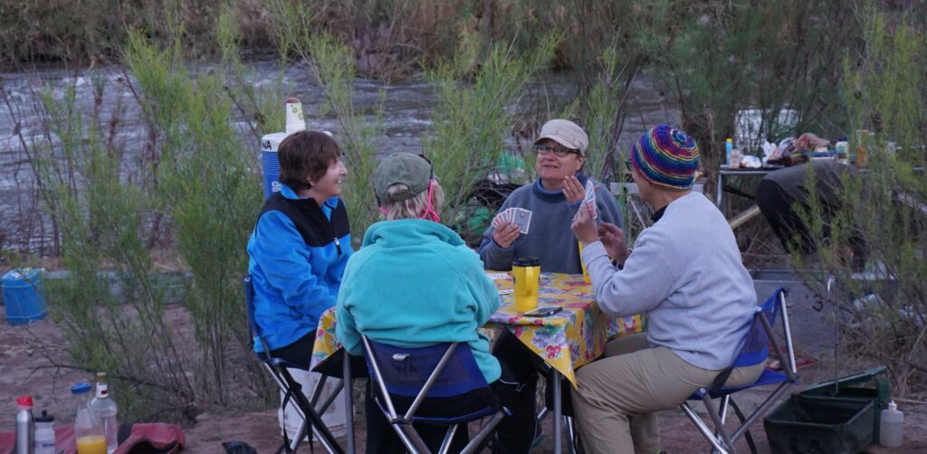 Four friends at camp after multi-day salt river white water rafting