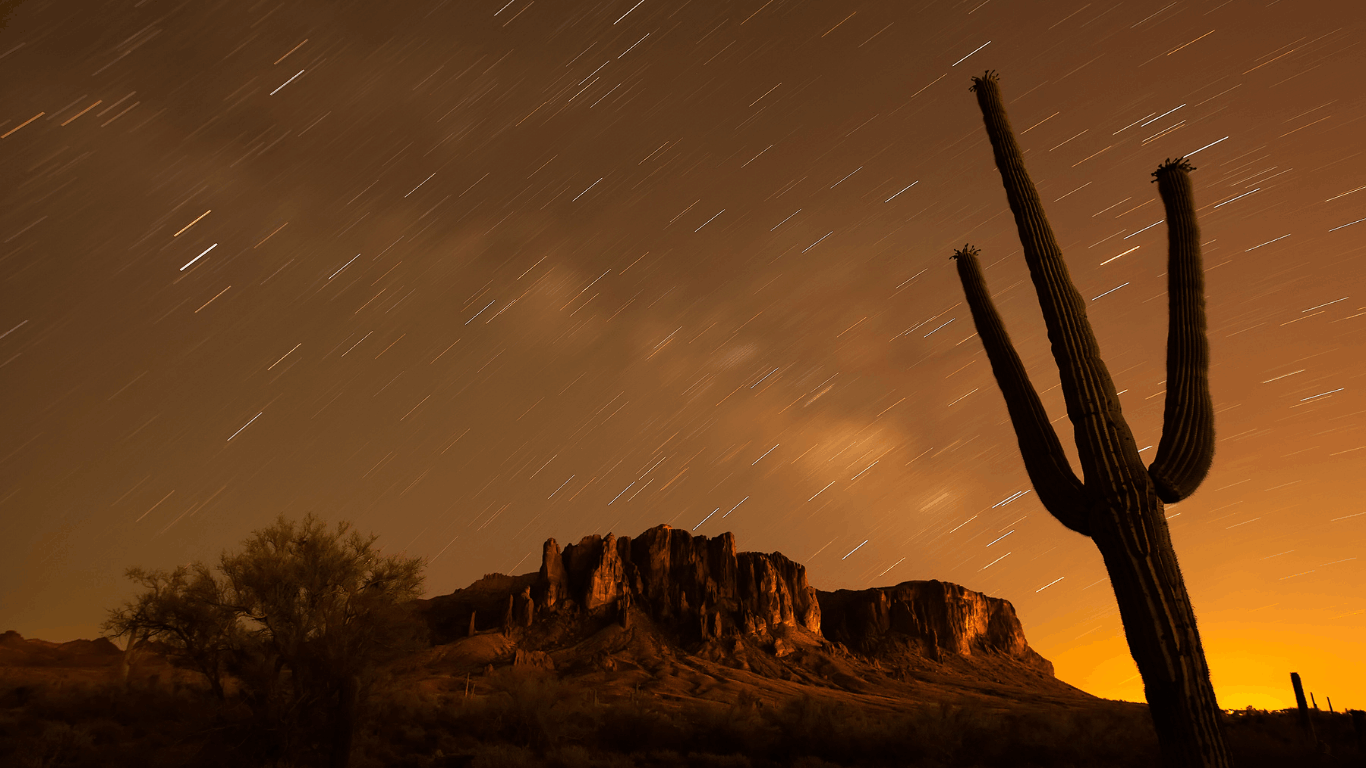 stars above lost dutchman state park in arizona as the sun rises